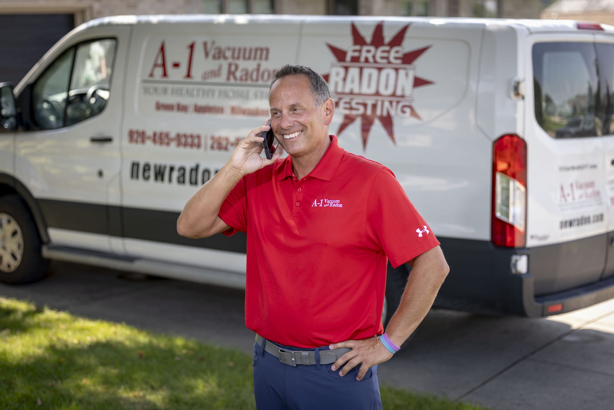 A radon mitigation contractor who used AdeptPlus Radon Marketing / Web Design talking on his phone to new leads