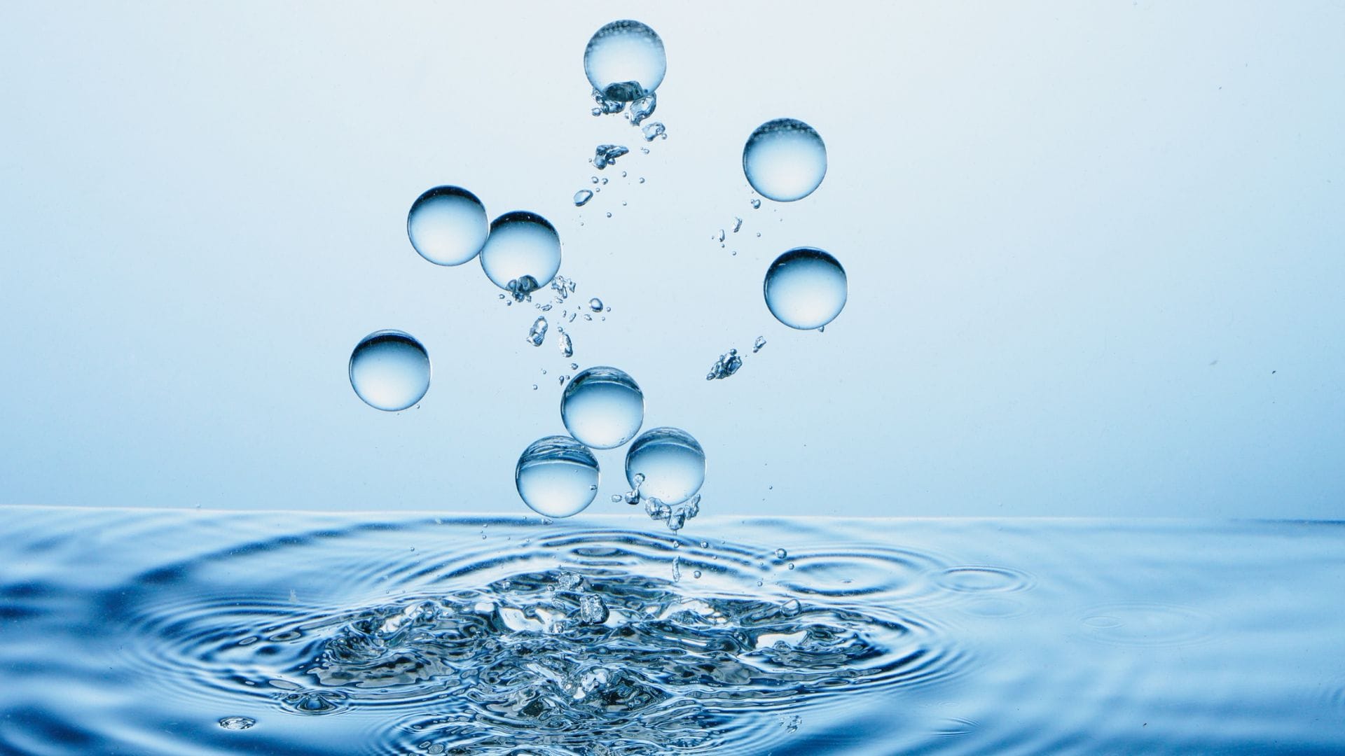 Pool contractor in blue overalls cleaning a residential pool, representing AdeptPlus web marketing services for pool companies